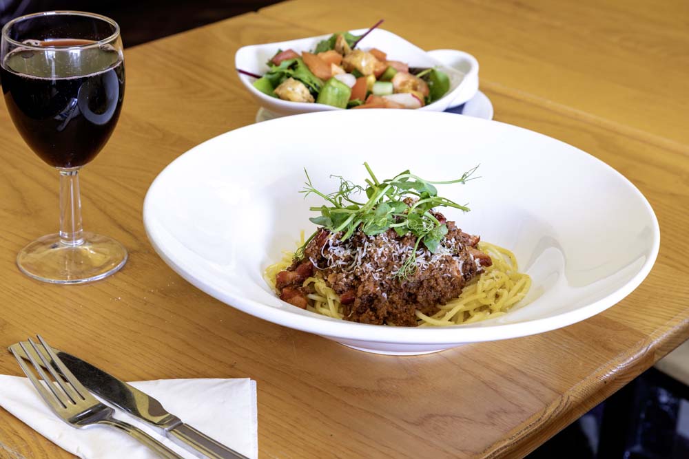 Spaghetti bolognese with side salad and red wine