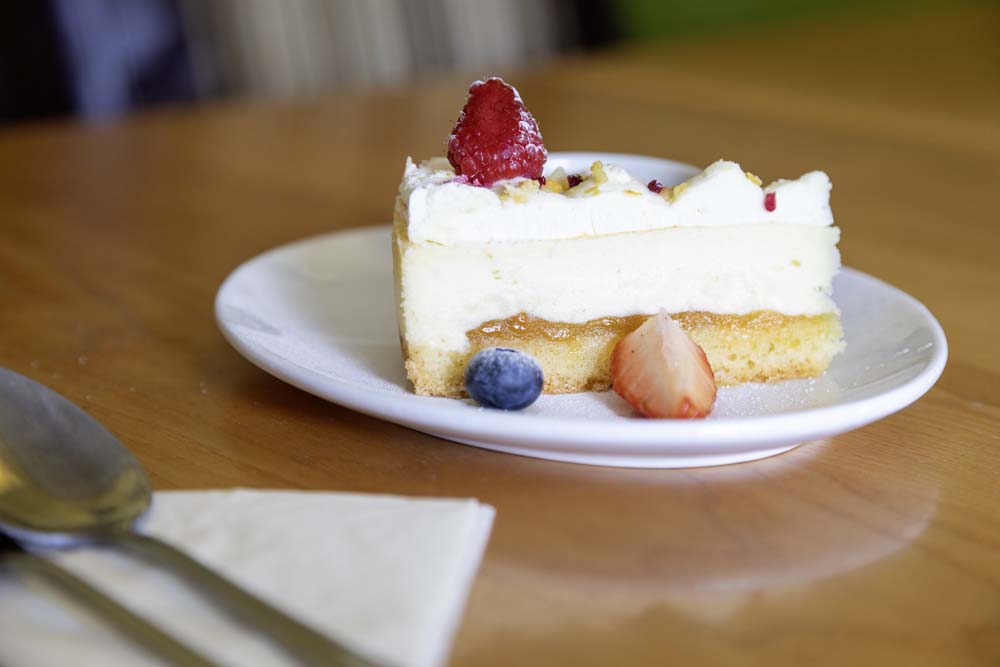 Slice of cheesecake topped with fresh berries