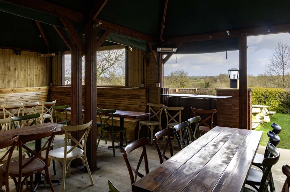 Covered patio seating with countryside views