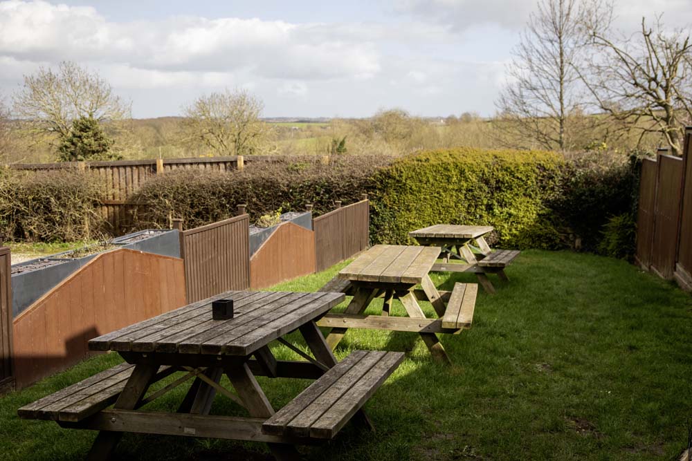 Beer garden picnic benches overlooking open countryside