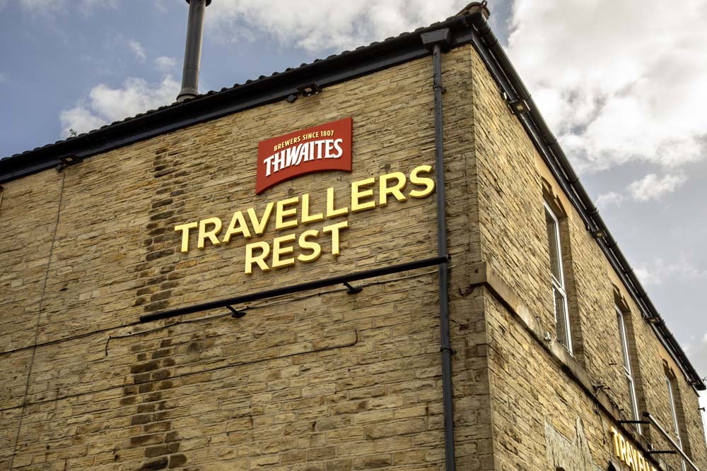 Travellers Rest exterior sign on stone wall
