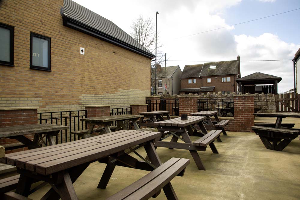 Paved outdoor courtyard with picnic benches