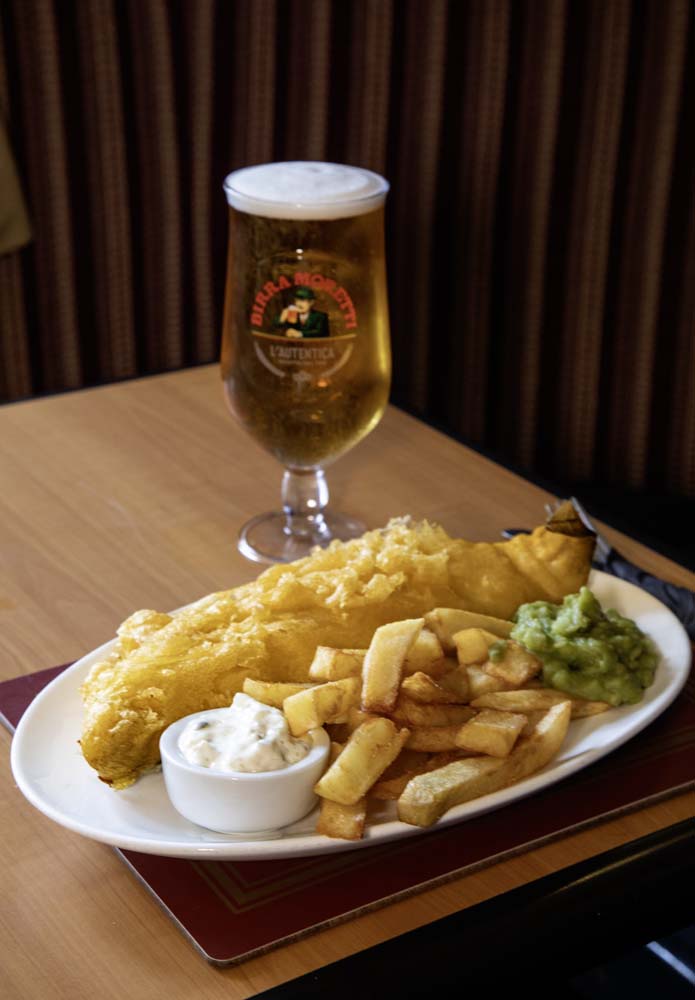 Battered fish and chips with mushy peas